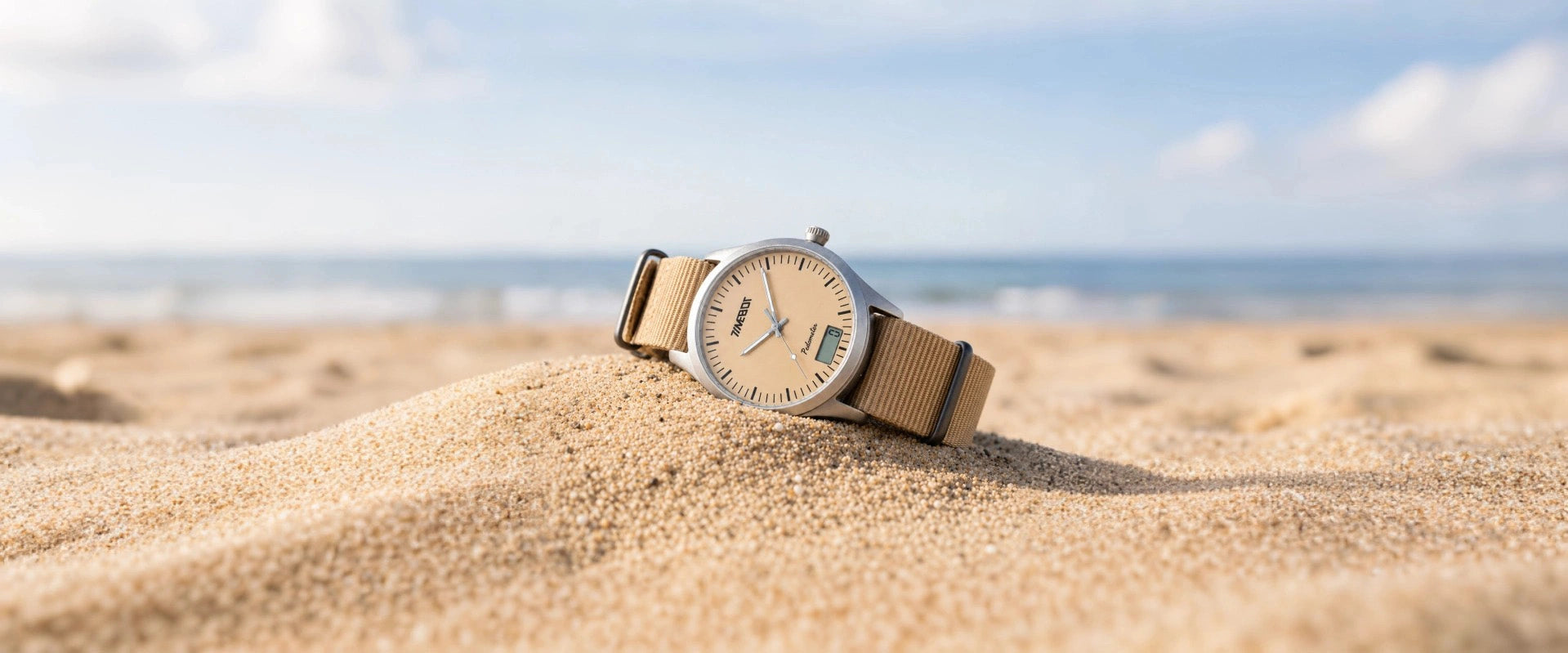Timebot T591C6 hybrid pedometer watch on a sand dune with a clear sky